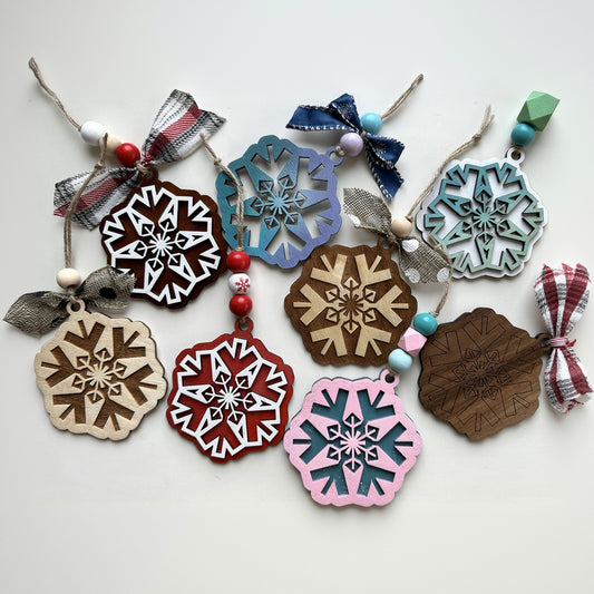 Colorful snowflake-shaped wooden ornaments on a white background