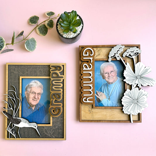 Two wooden photo frames with 'Grampy' and 'Grammy' text, featuring portraits of elderly individuals on a pink background.