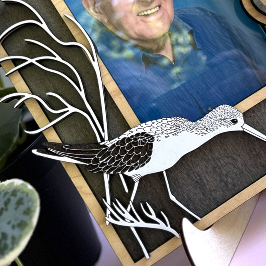Decorative piece with a bird illustration and a person's face in the background