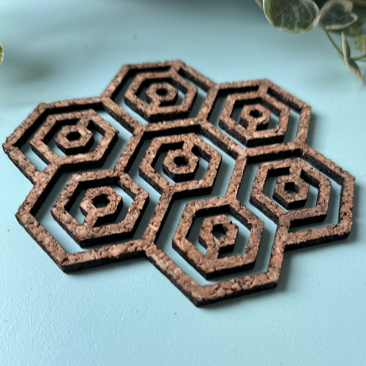 A honeycomb trivet on a light background