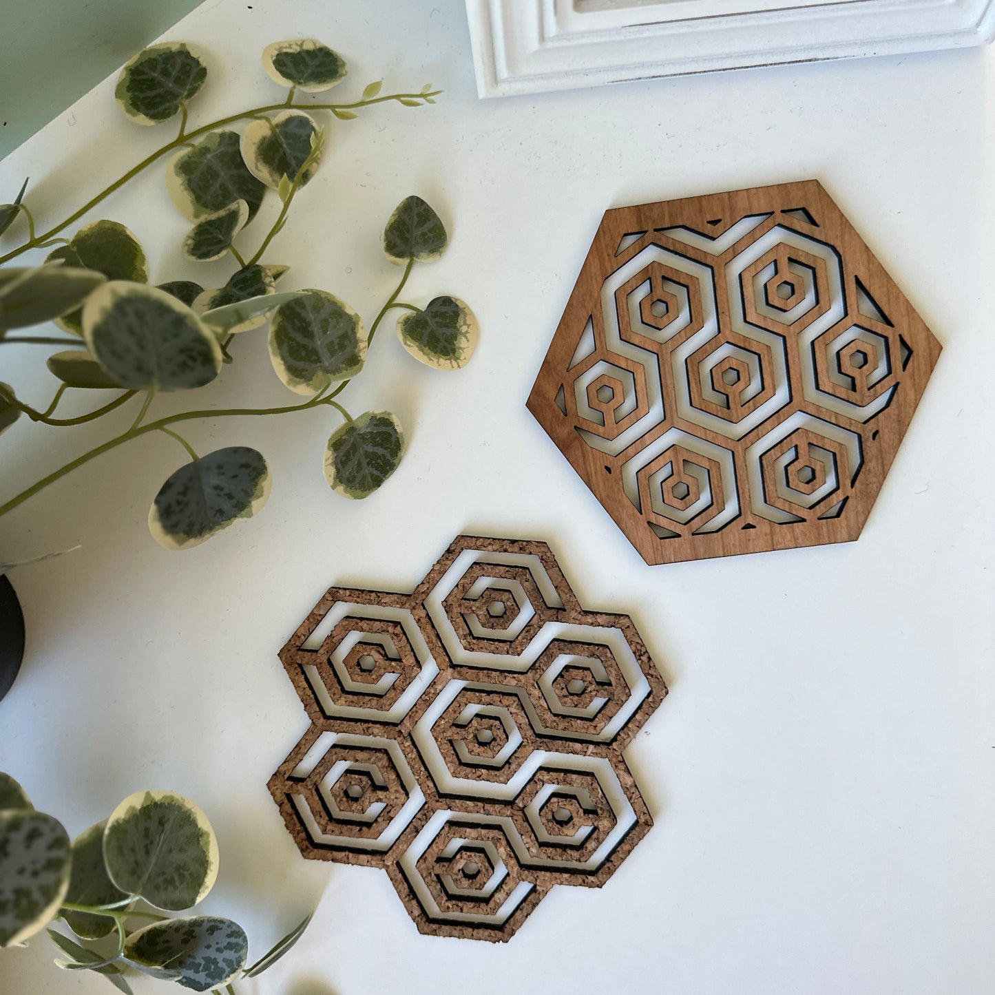Two honeycomb trivets on a light background