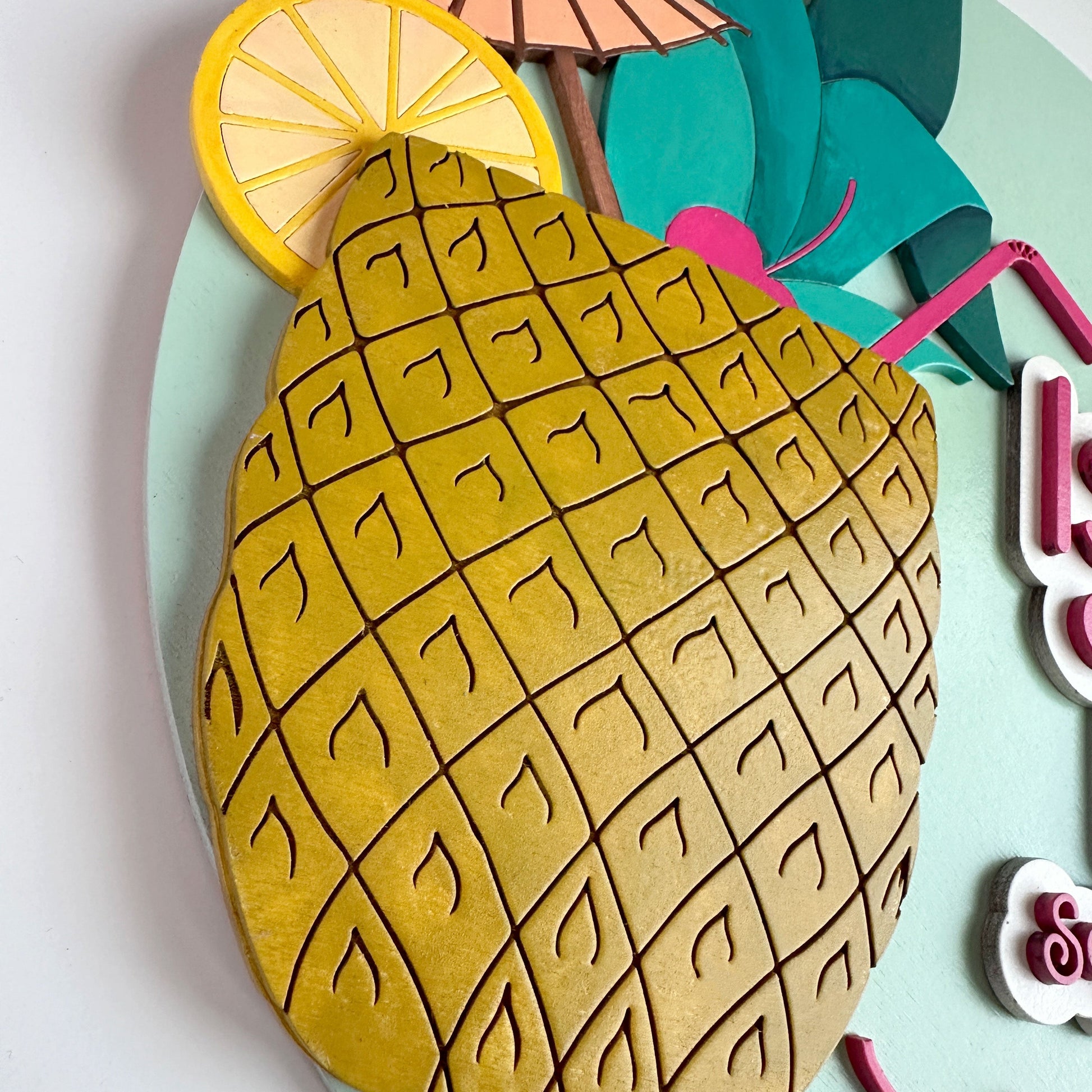 Pineapple-shaped cookie with lemon slice and umbrella on a light blue background