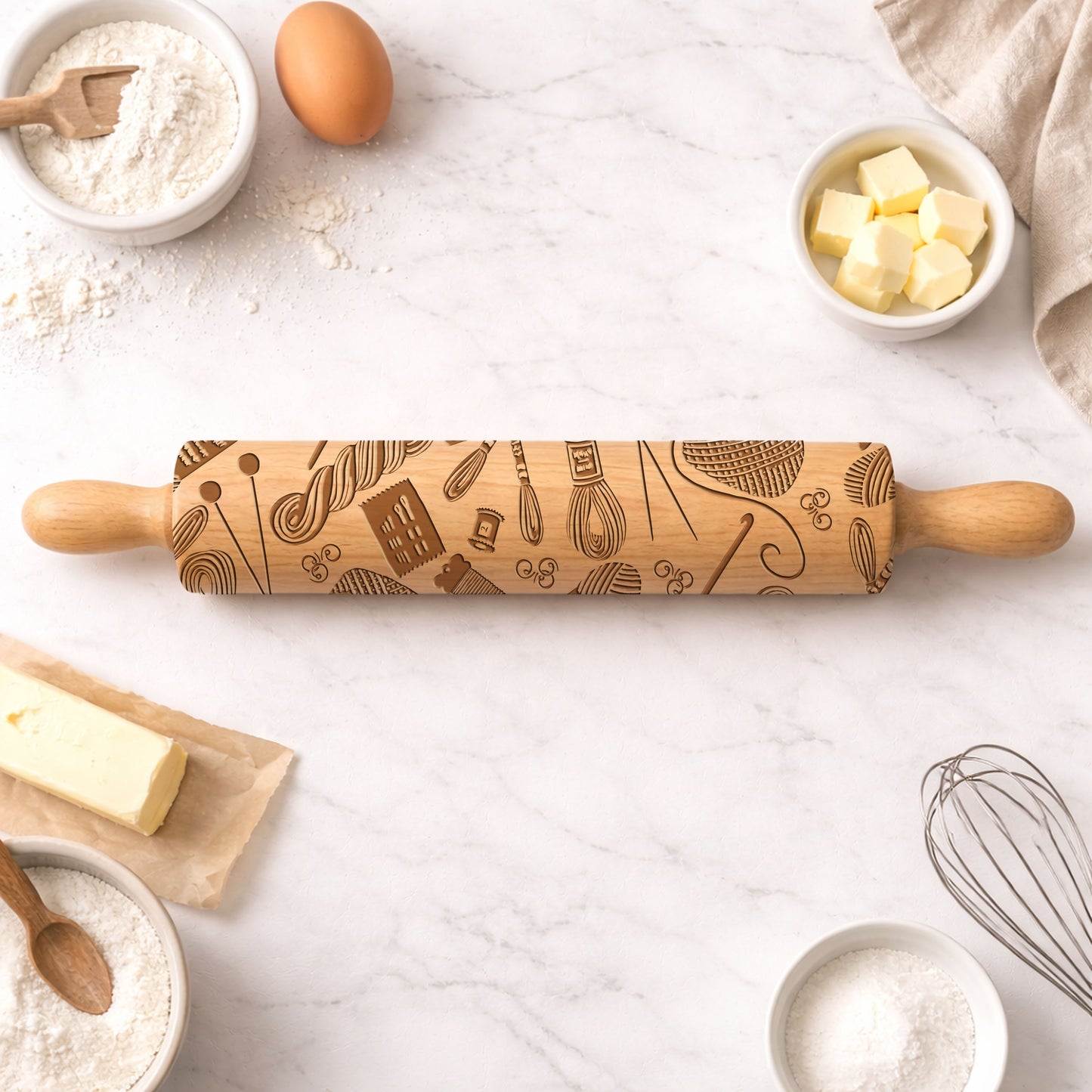 Wooden rolling pin with baking-themed design on a kitchen counter with ingredients.
