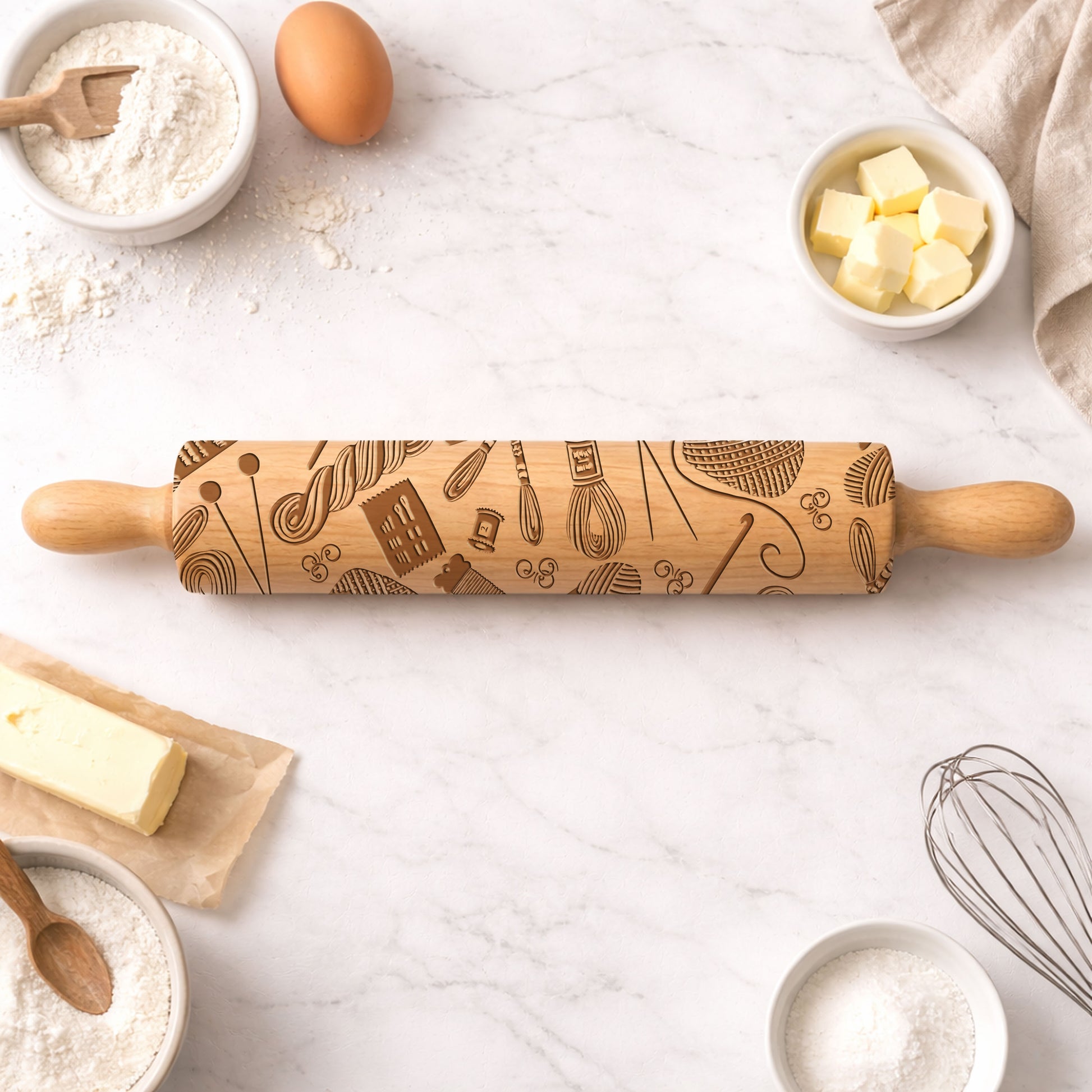 Wooden rolling pin with baking-themed design on a kitchen counter with ingredients.