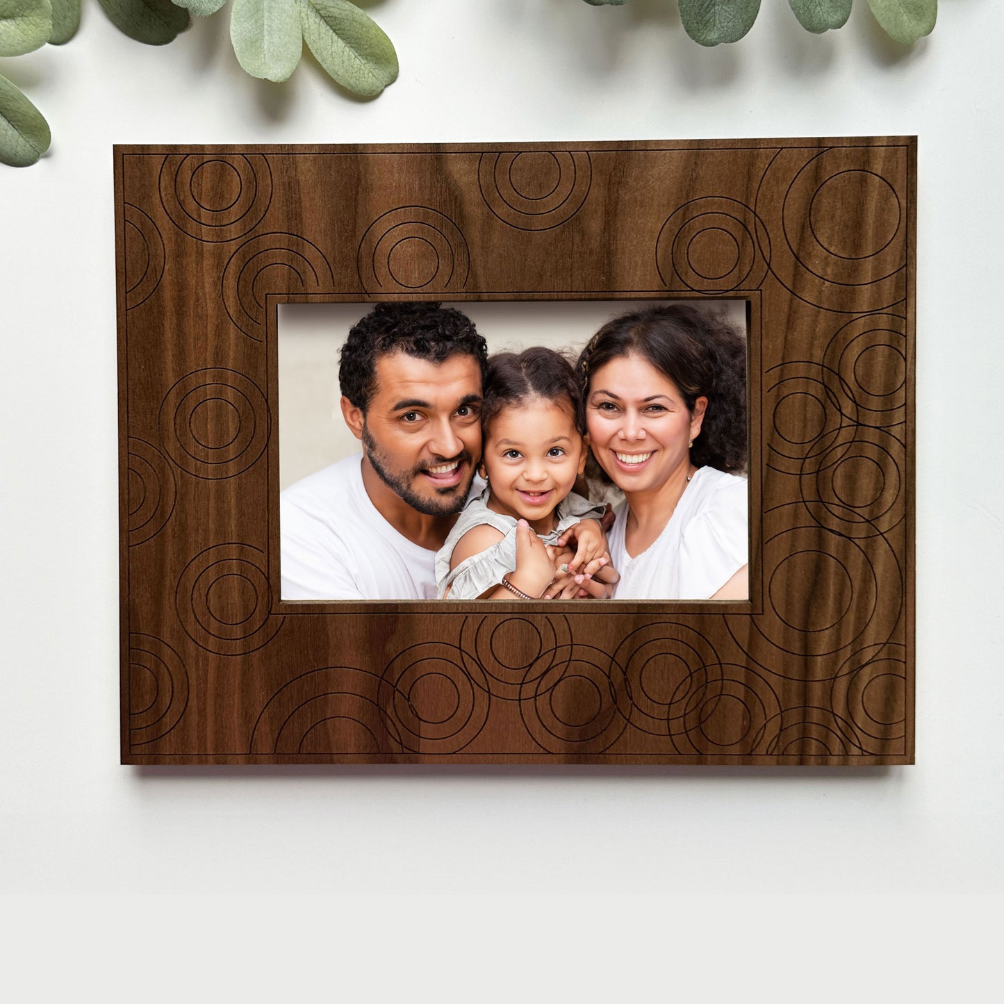 Wooden photo frame with a family portrait on a white background