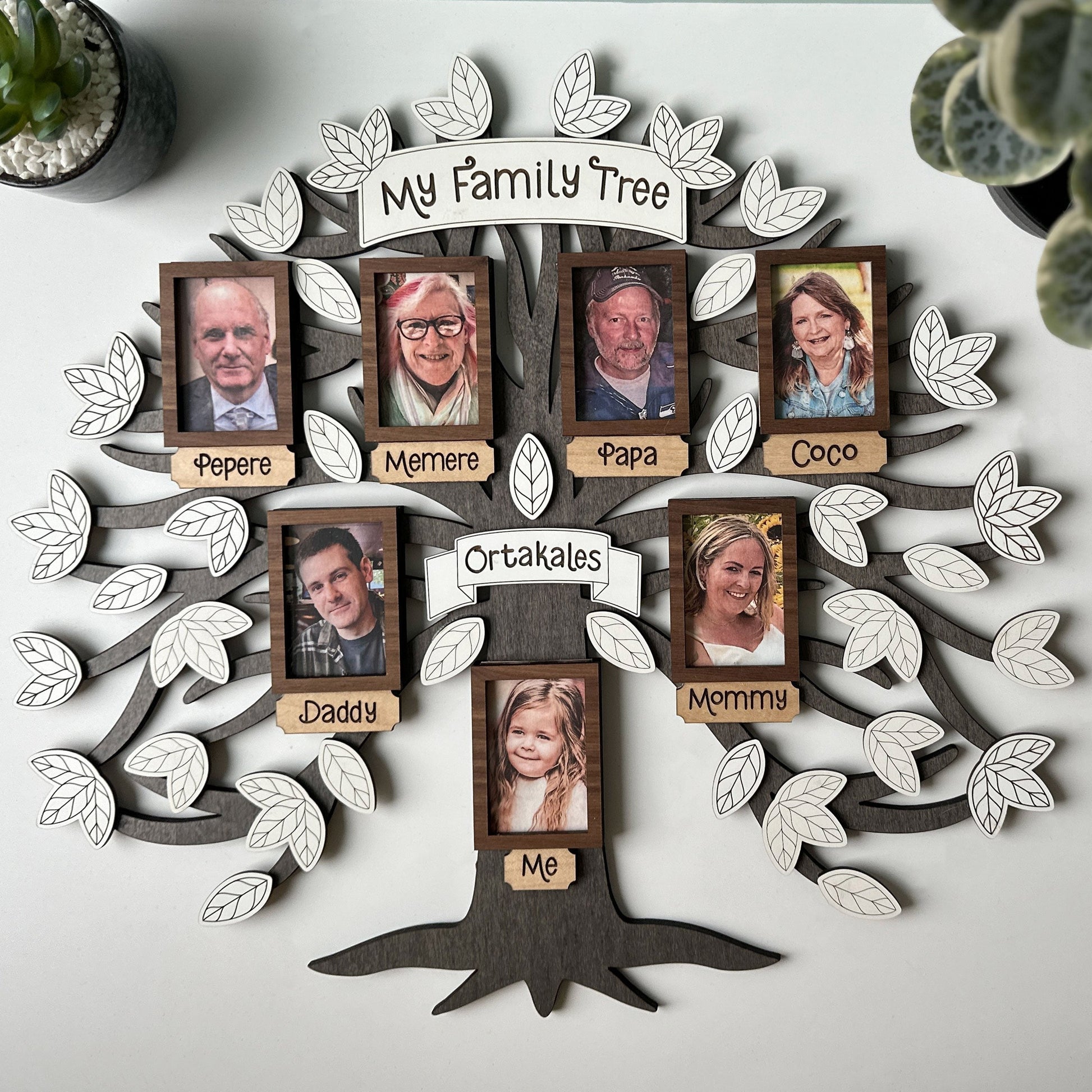 Family tree wall decoration with family photos on a white background