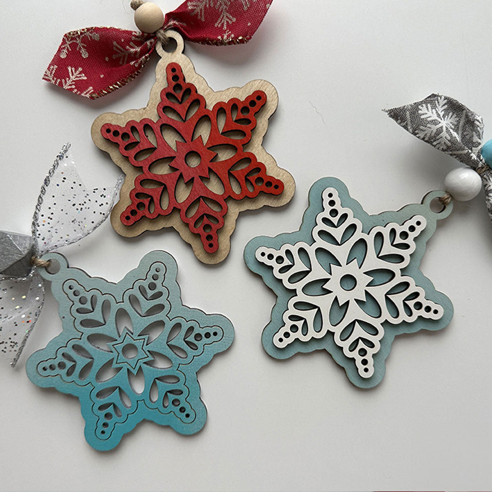 Decorative snowflake ornaments with ribbons on a light background