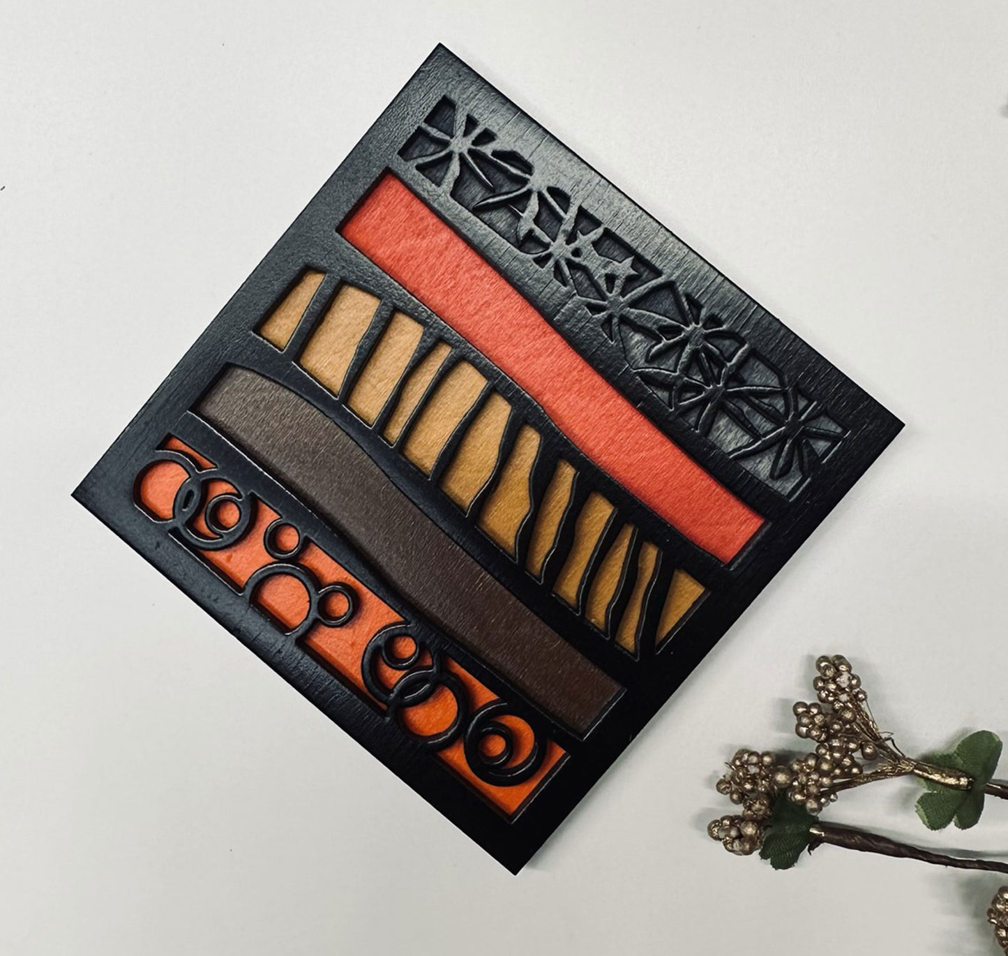 Coaster with brown and orange shades on a light gray background.