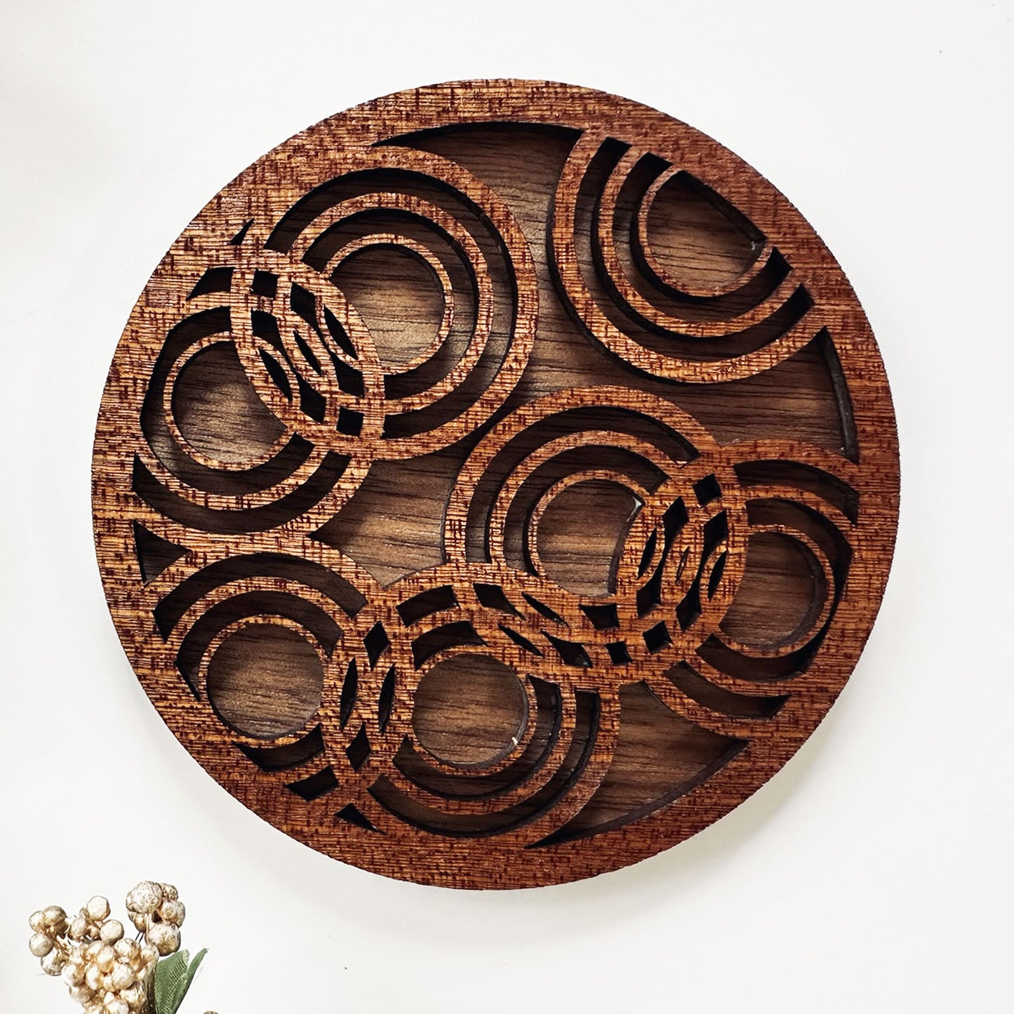 Wooden coaster with geometric patterns on a white background