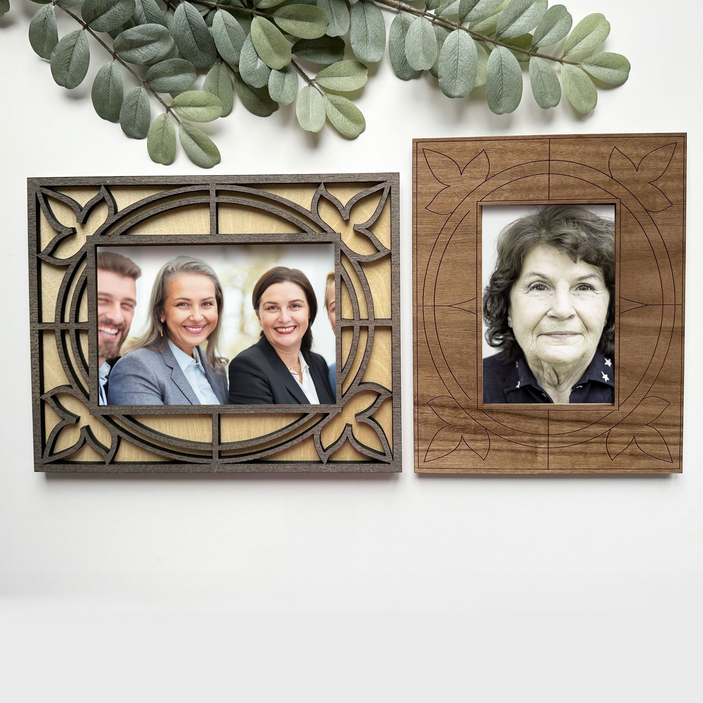 Two wooden picture frames with cut-out designs, one containing a family photo and the other a portrait of an elderly woman.