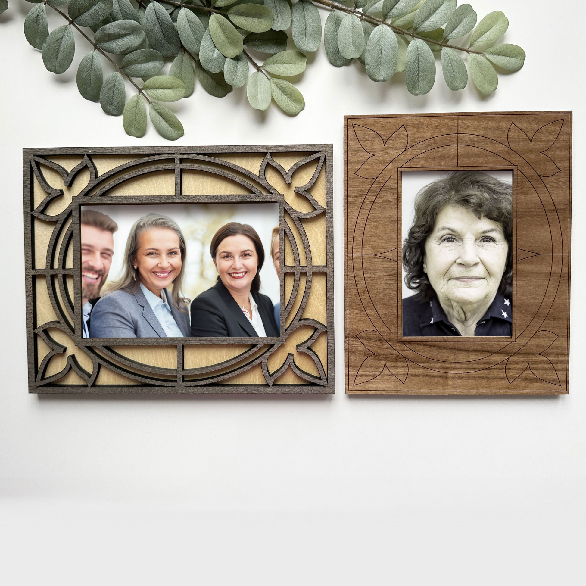 Two wooden picture frames with cut-out designs, one containing a family photo and the other a portrait of an elderly woman.