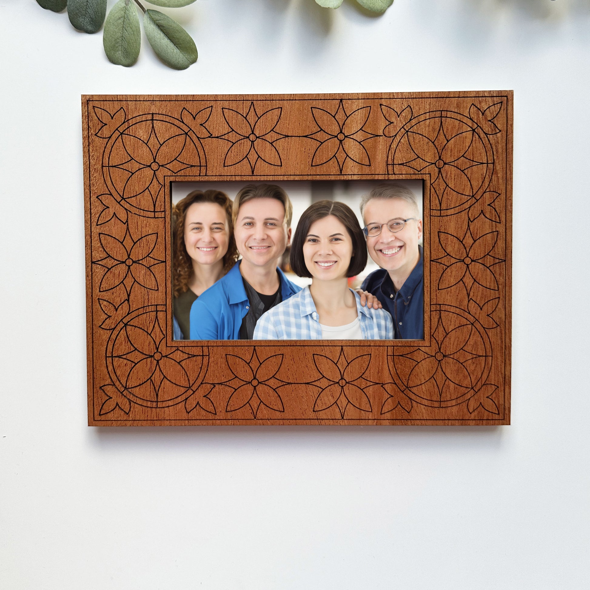 Wooden photo frame with family portrait on a white background