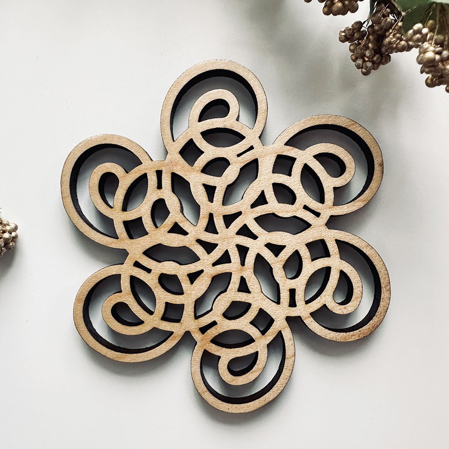 Decorative wooden coaster on a light background