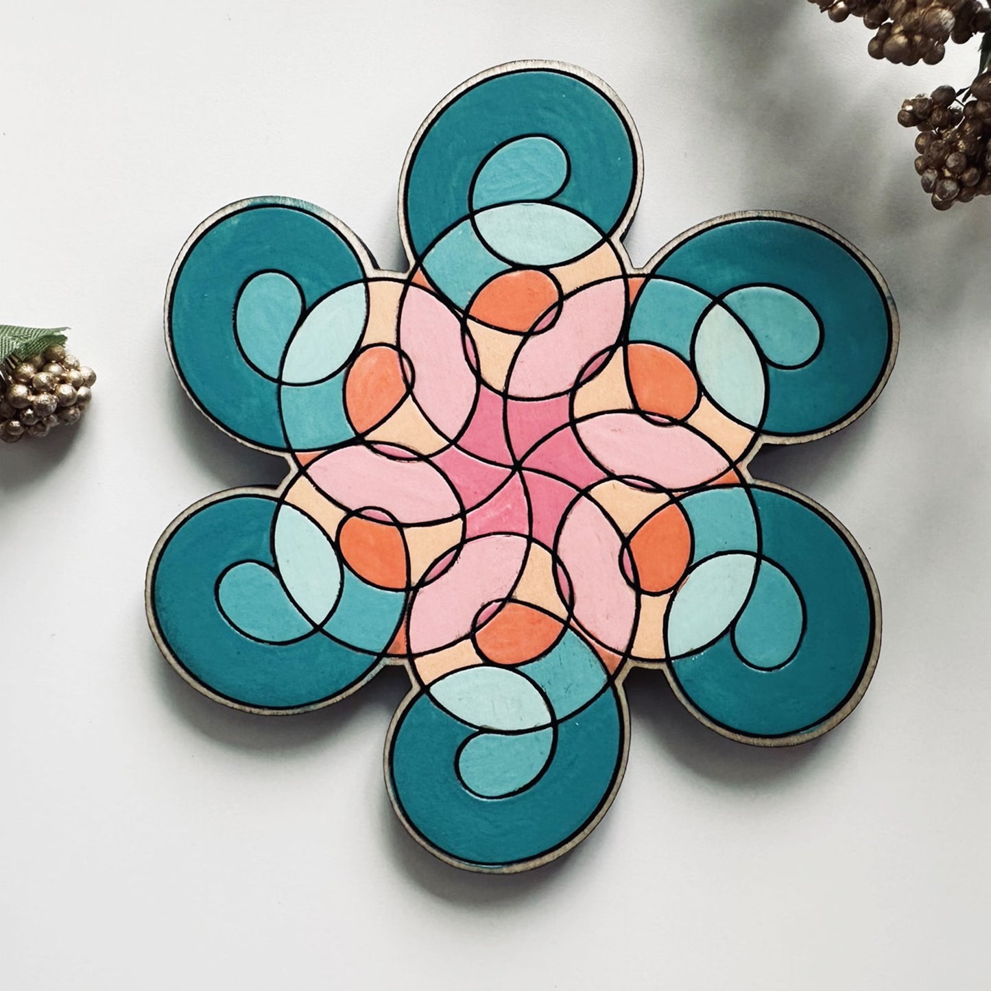 Colorful geometric flower coaster on a white background