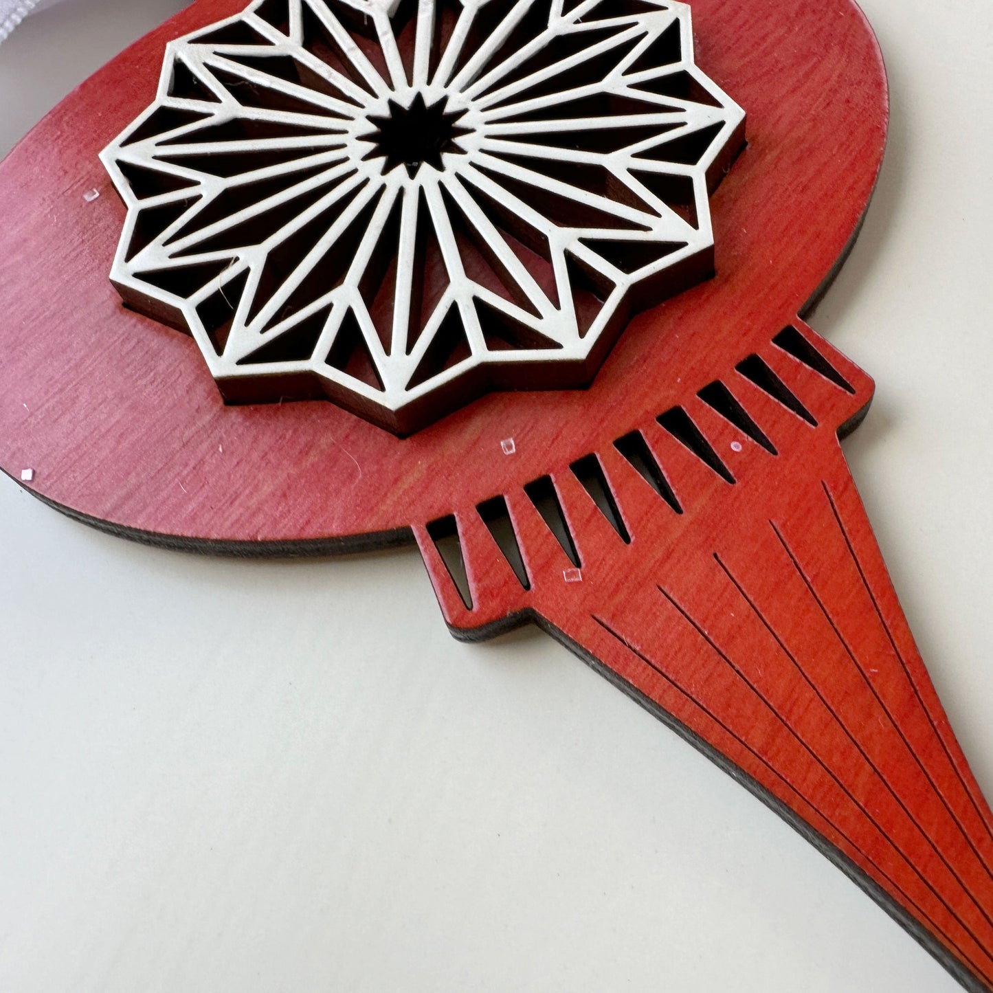 Wooden wall art with geometric design on a white background